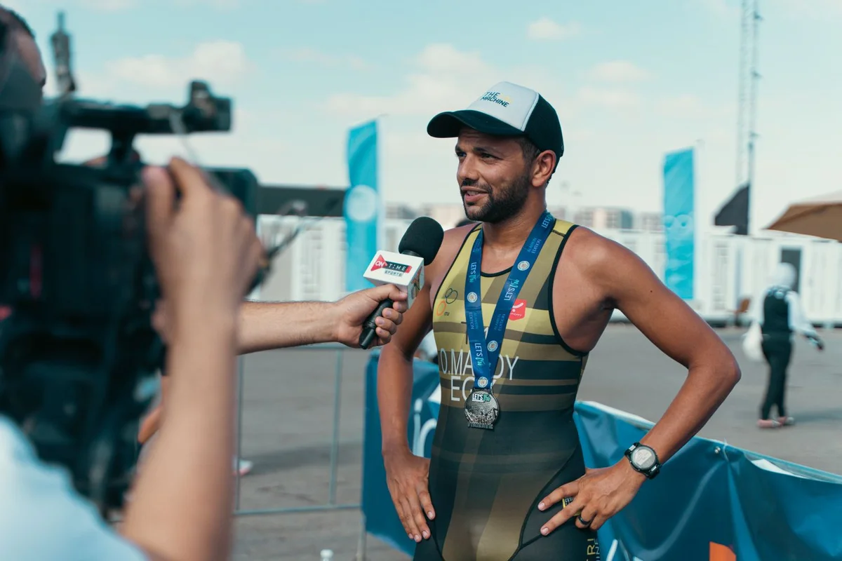 An athlete speaking to a reporter after a race