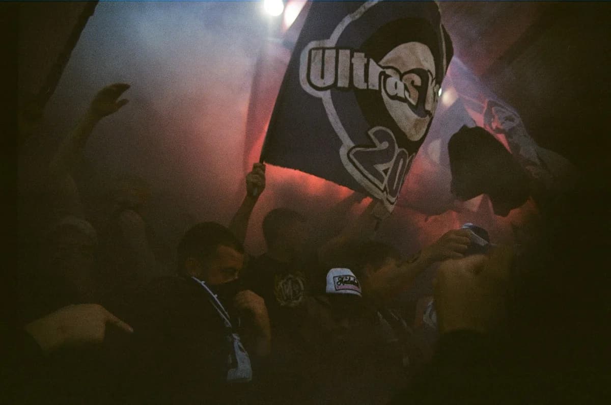 Club supporters waving flags in the stands